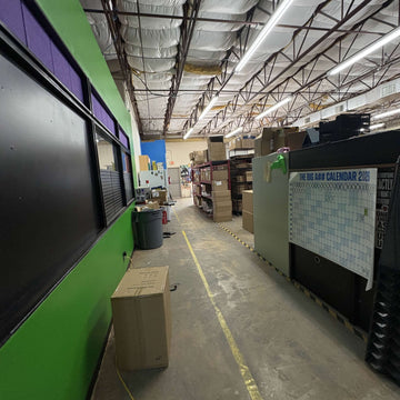 Packed, organized shelves inside the Laguna Studios fulfillment warehouse