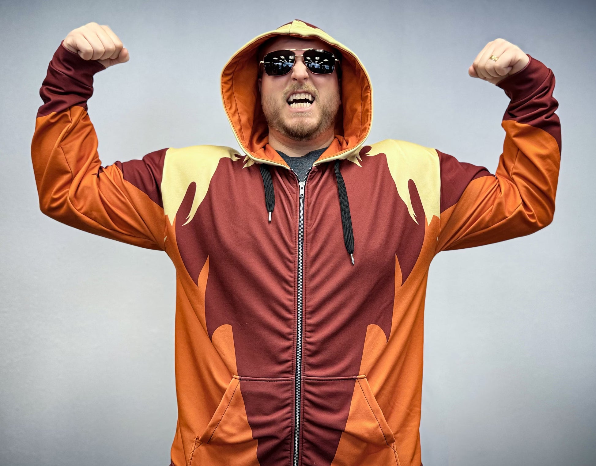 Swordfang Zip-up Hoodie featuring bold colors and a confident model showcasing its unique design.