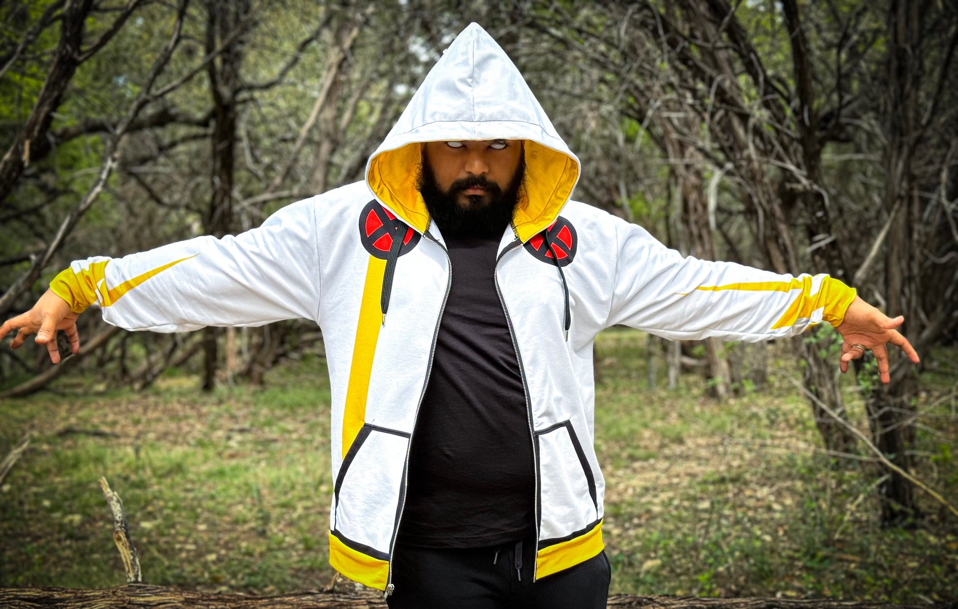 Weather Witch Zip-up Hoodie worn by person in a forest, showcasing its vibrant design and cozy fit.