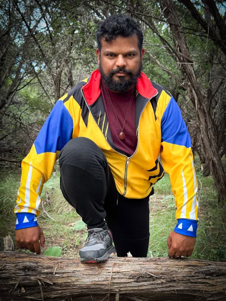 Man wearing the Badger Track Jacket from Laguna Studios outdoors, showcasing a bold 90s-inspired design.