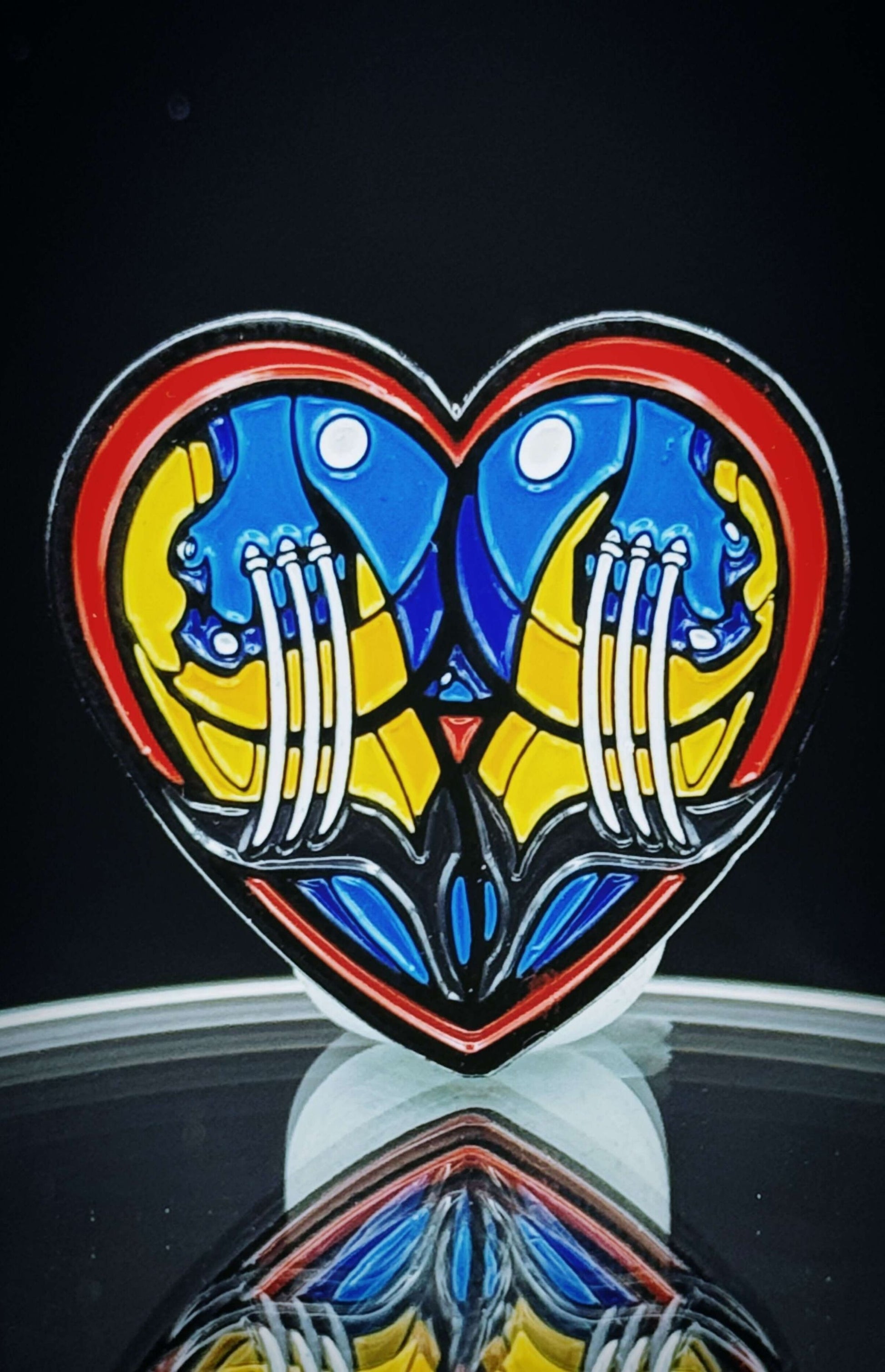 Heart-shaped enamel pin featuring colorful mutant heroes, perfect for adding humor to any outfit.