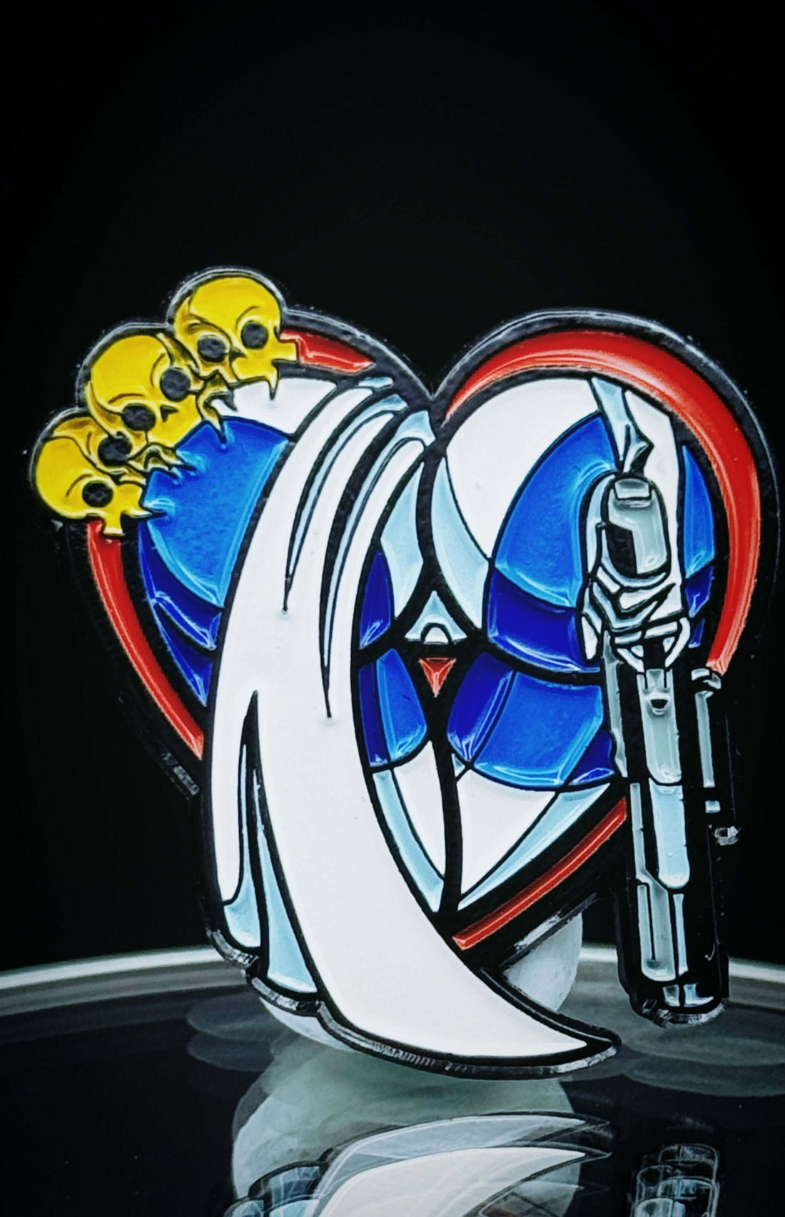 Colorful Shapeshifter Ass-Tonishing Pin featuring a heart design with skulls and a weapon, perfect for comic fans.