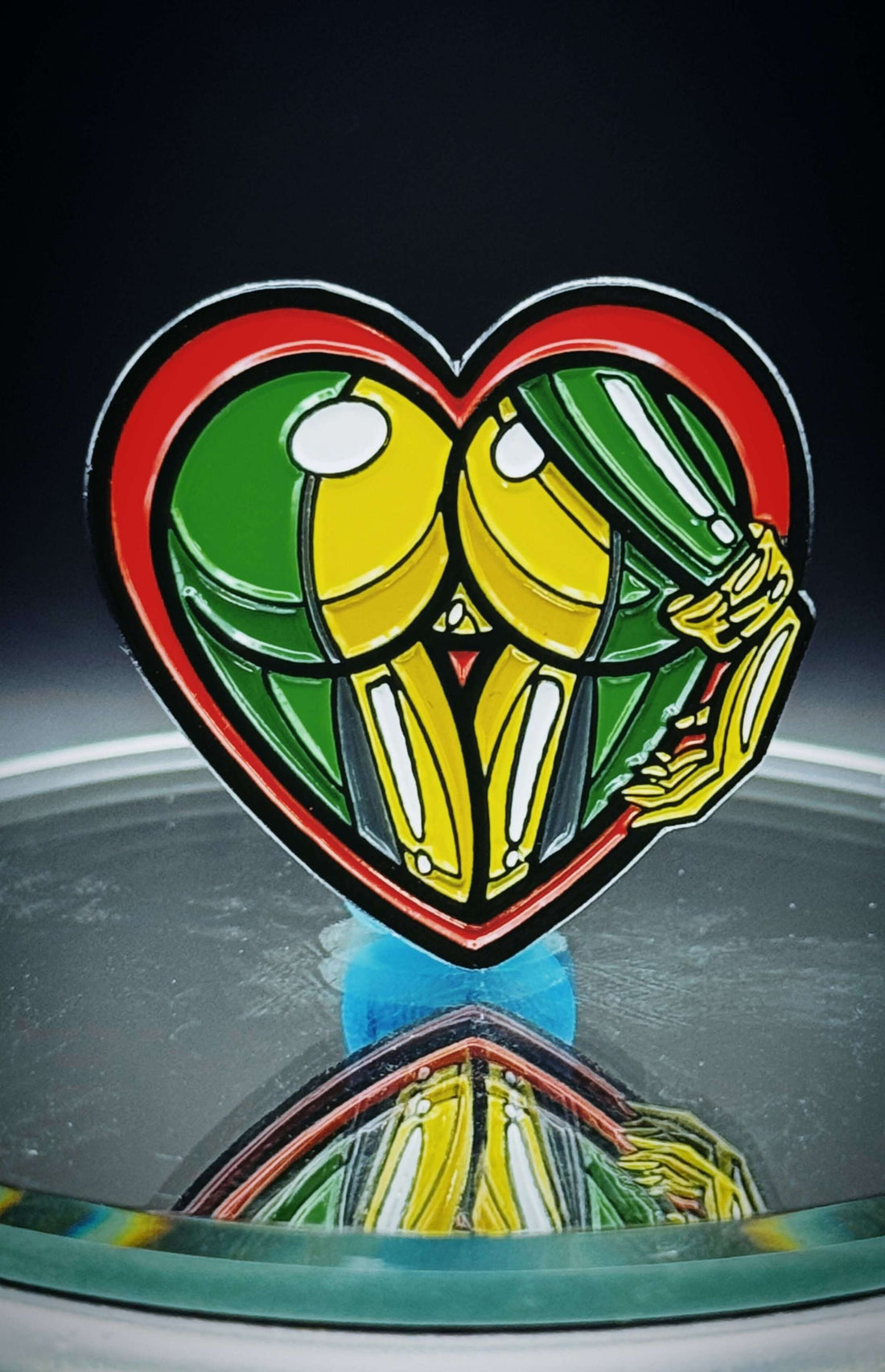 Enamel pin featuring a heart design with playful mutant hero aesthetics, perfect for collectors and comic lovers.