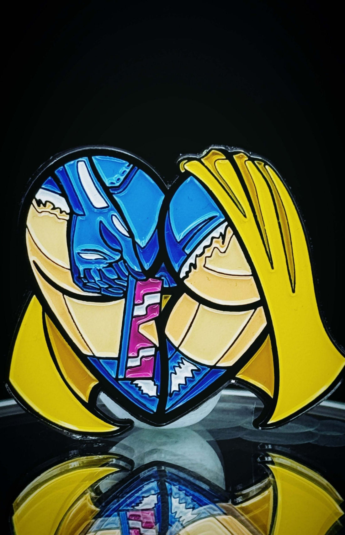 Colorful enamel heart-shaped pin featuring comic-style figures in a playful embrace, perfect for collectors and enthusiasts.