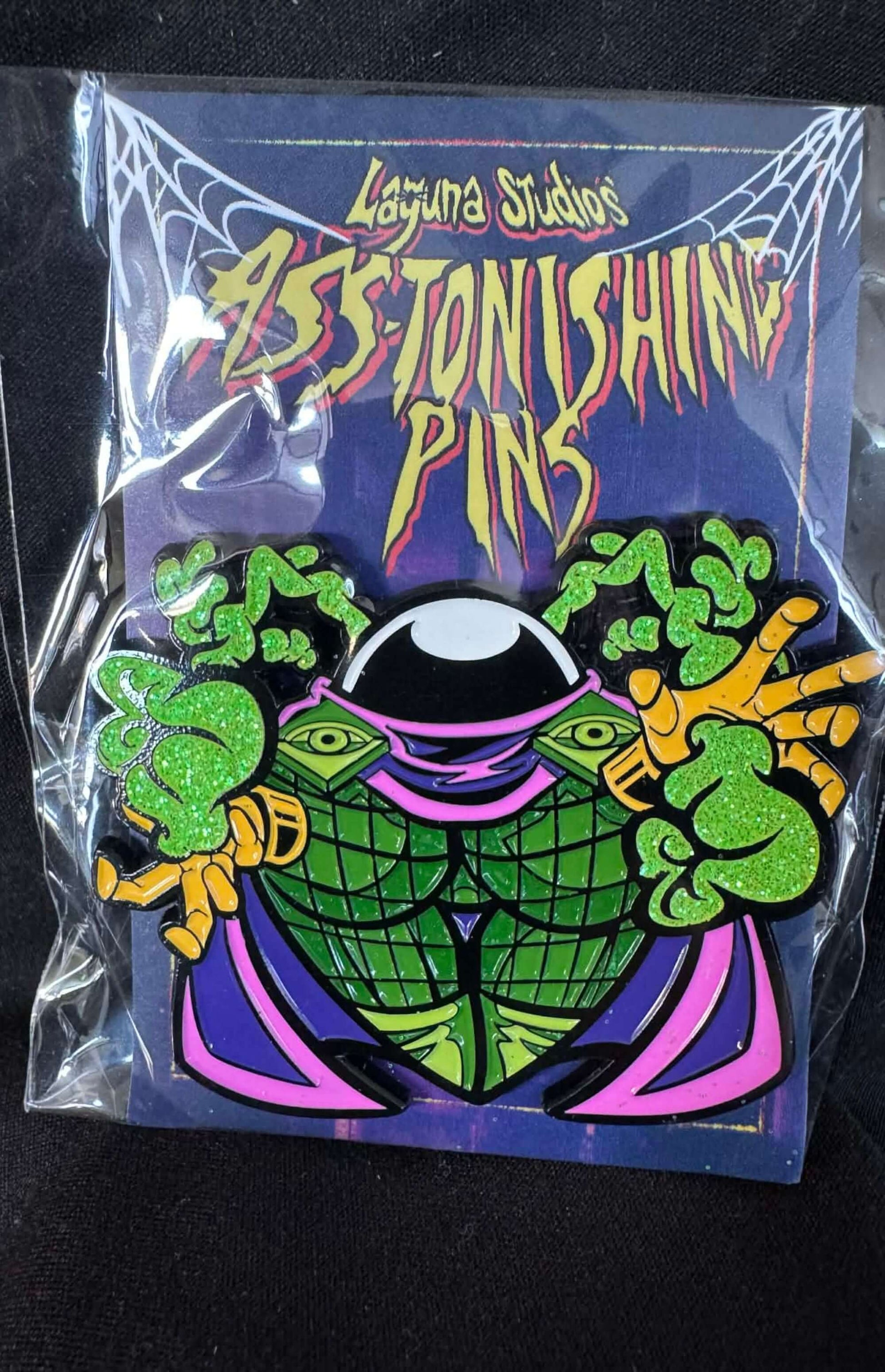 Conundro ASS-tonishing Pin from Laguna Studios, featuring vibrant colors and comic book design for collectors.