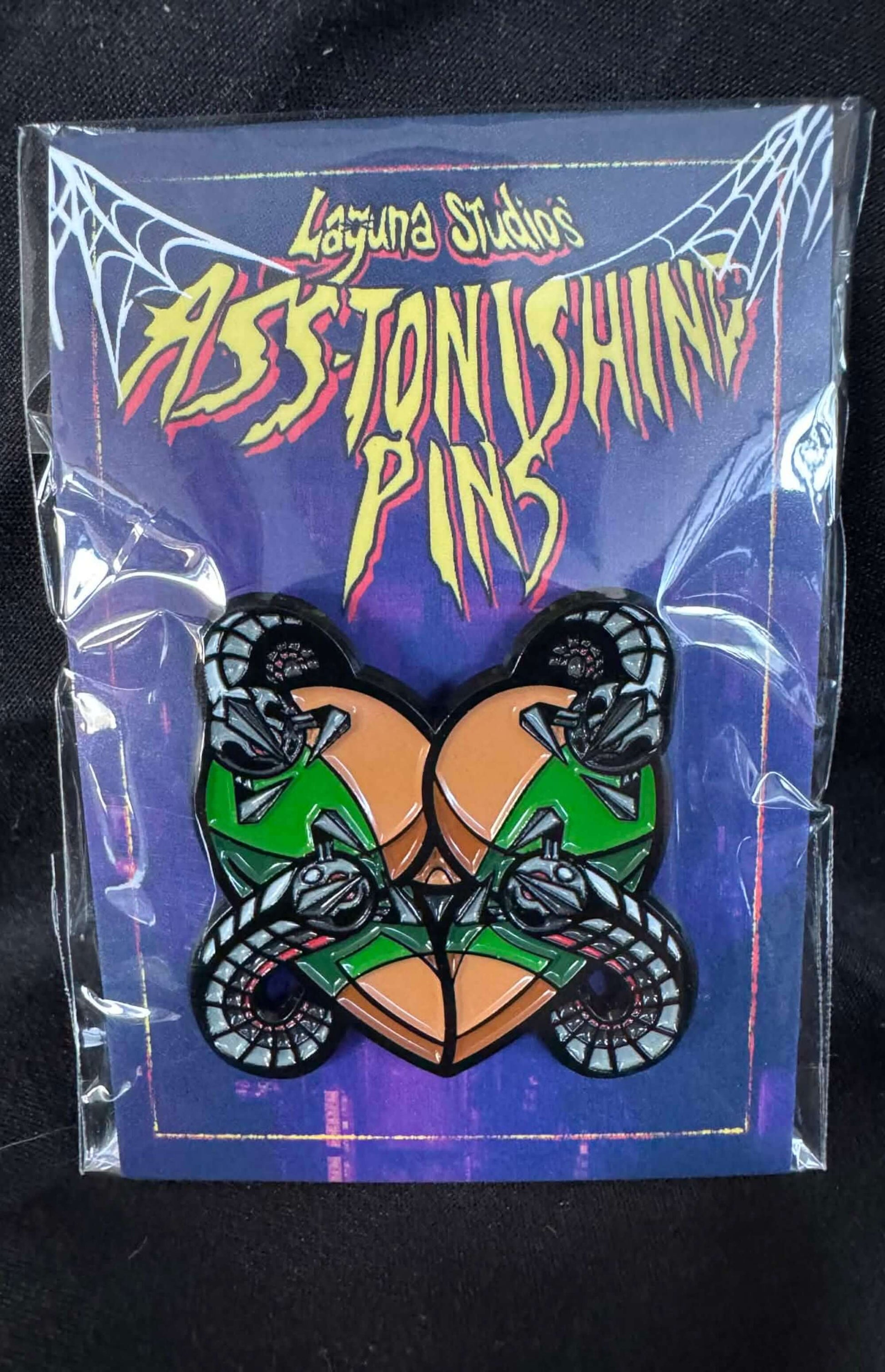 Profocho ASS-tonishing Pin displayed in packaging featuring bold colors and unique design by Laguna Studios.