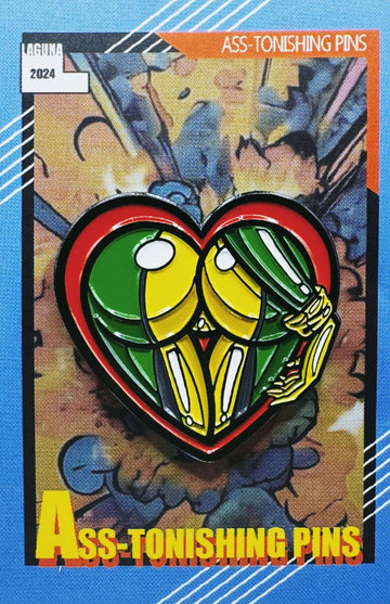 Colorful heart-shaped pin showing cartoonish buttocks, titled 'Ass-tonishing Pins,' on a vibrant background.