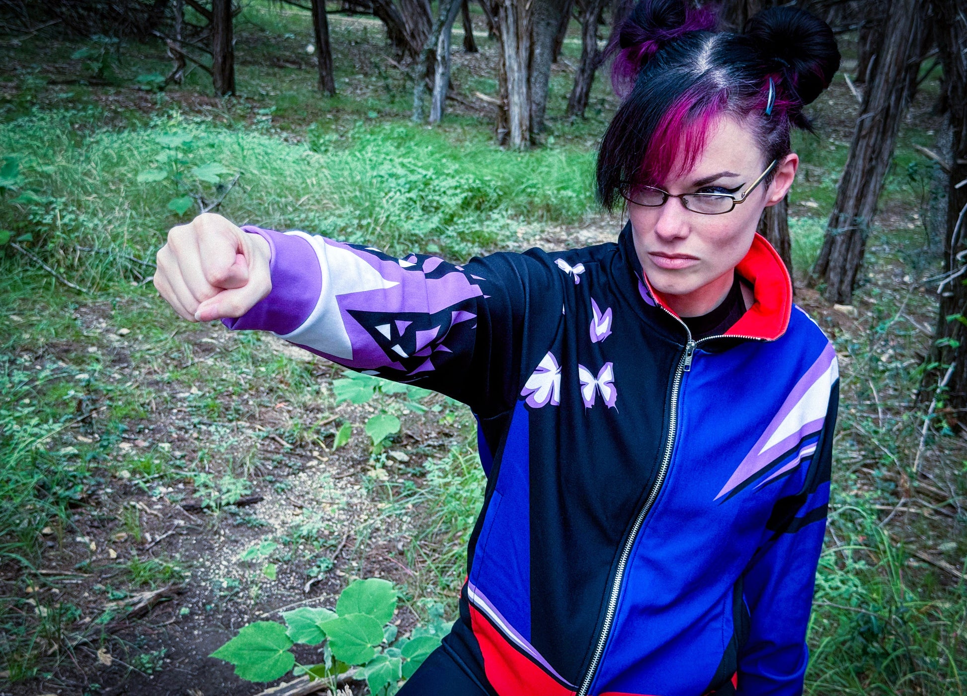 Model showcasing the Psychic Ninja Track Jacket in a forest, striking a confident pose with a determined look.