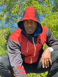 Man wearing a Blue BAMF Zip-up Hoodie in a park, showcasing its striking design and comfortable fit.