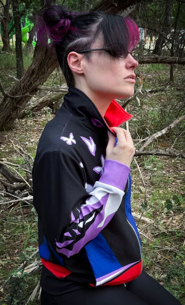 Model wearing the Psychic Ninja Track Jacket in a natural setting, showcasing its retro superhero design and vibrant colors.