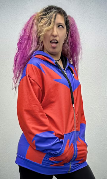 Woman posing in Magnet Master Zip-up Hoodie with vibrant red and blue design, showcasing bold comic book style.